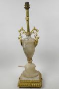 A gilt metal and alabaster table lamp in the form of a classical urn on square stepped pedestal, 19"
