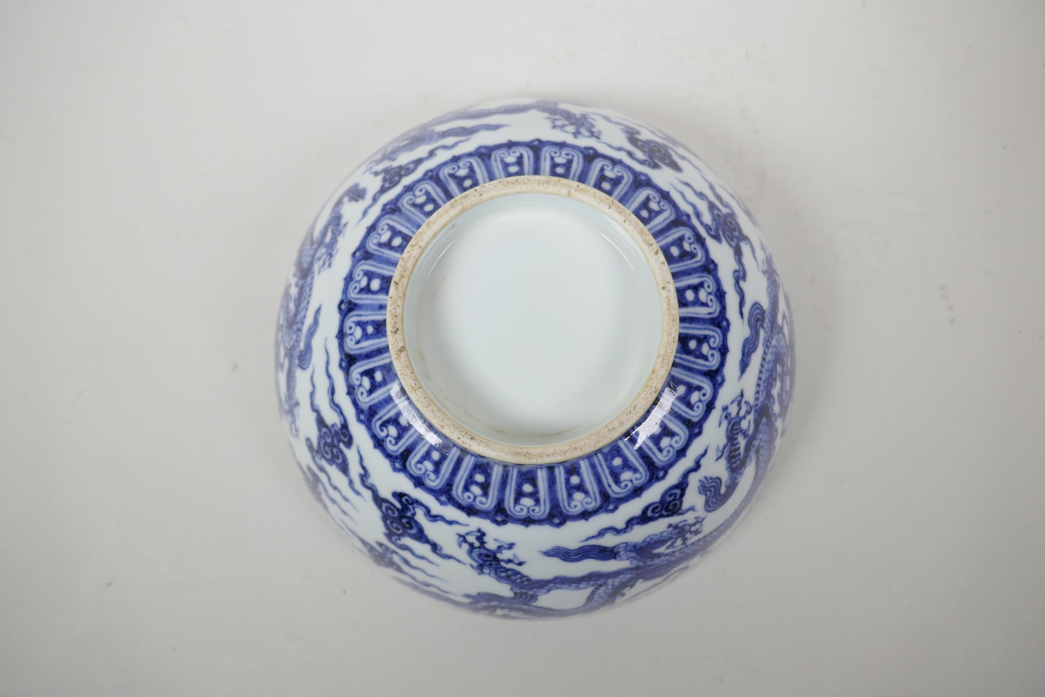 A Chinese blue and white porcelain bowl decorated with two dragons, 6 character mark to lip, 9" - Image 6 of 6