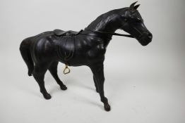 A leather horse with saddle and reins, 10½" high