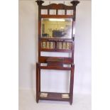 A Victorian Art Nouveau walnut hall stand, with mirrored and tiled back, some losses, 34" x 11" x