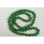 A string of apple green jade beads, 32" long