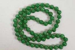 A string of apple green jade beads, 32" long