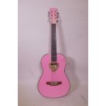 A Candyrox pink acoustic guitar, 36" long