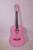 A Candyrox pink acoustic guitar, 36" long