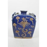 A Chinese blue glazed pottery flask with four dragon shaped handles and chased phoenix decoration,