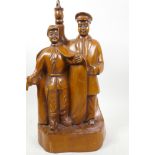 A Chinese Republic carved wood figure of two men, one with gun, 16" high