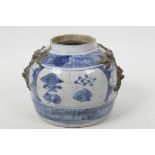 An antique Chinese blue and white storage jar with applied dragon mask decoration and painted with