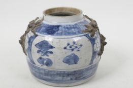 An antique Chinese blue and white storage jar with applied dragon mask decoration and painted with