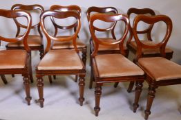 A set of eight Victorian walnut kidney back dining chairs, with screwed back legs, raised on
