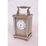 A brass and silver plated carriage clock, the silver faceplate with enamel dial, inscribed G.