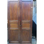 A C19th mahogany wardrobe, with panelled doors, raised on bracket supports, 41" x 20" x 77"