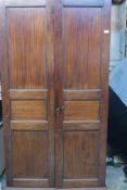 A C19th mahogany wardrobe, with panelled doors, raised on bracket supports, 41" x 20" x 77"