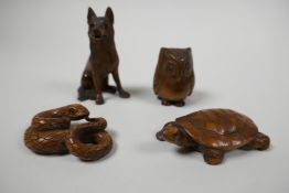 Four Japanese wooden netsuke, intricately carved boxwood figures of a snake, turtle, owl and wolf,