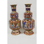 A pair of clobbered Chinese porcelain vases of double gourd form with slender necks, painted with