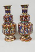 A pair of clobbered Chinese porcelain vases of double gourd form with slender necks, painted with