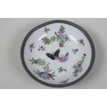 An unusual Chinese porcelain dish painted with butterflies and flowers in an unusual pewter outer