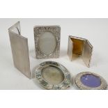 A small hallmarked silver photo frame, 2½" diameter overall, together with four silver plated