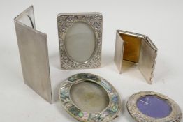 A small hallmarked silver photo frame, 2½" diameter overall, together with four silver plated