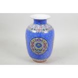 A Chinese blue vase with polychrome panels with stylised dragon and foliate decoration, seal mark to