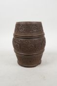 An Indian turned and carved wood pot with floral decoration, 5½" high