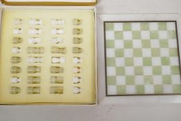 A small boxed onyx chess set and board, 10" square