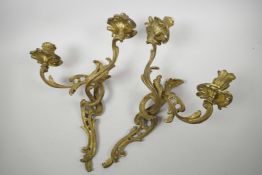 A pair of ormolu two light wall sconces of scrolling leaf design, 17" high