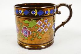 A large early Victorian Sunderland copper lustre mug, hand painted with brightly coloured flowers,