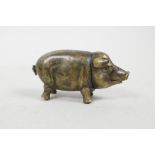 A novelty brass vesta case in the form of a pig, 2½" long