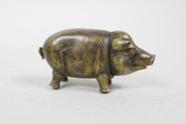 A novelty brass vesta case in the form of a pig, 2½" long