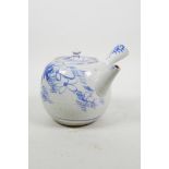 An Oriental blue and white Kyusu style teapot with floral decoration, A/F, 5" diameter