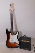 An Aria STG series electric guitar and practice amp, 39" long