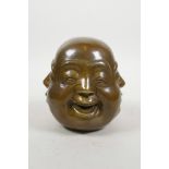 A Chinese filled bronze four faced Buddha head, 4½" high
