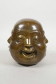 A Chinese filled bronze four faced Buddha head, 4½" high