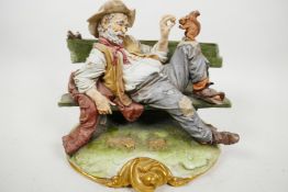 A Capodimonte figure of a scruffy old man sitting on a bench and feeding a squirrel, with birds