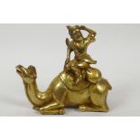 A Sino-Tibetan gilt bronze figure of a trader seated on a camel, 6" high