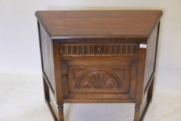 An oak credence cupboard, with single drawer over door and carved decoration, raised on turned
