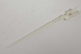 A Chinese white hardstone hairpin with a pierced spiral stem and dragon decoration, 9½" long