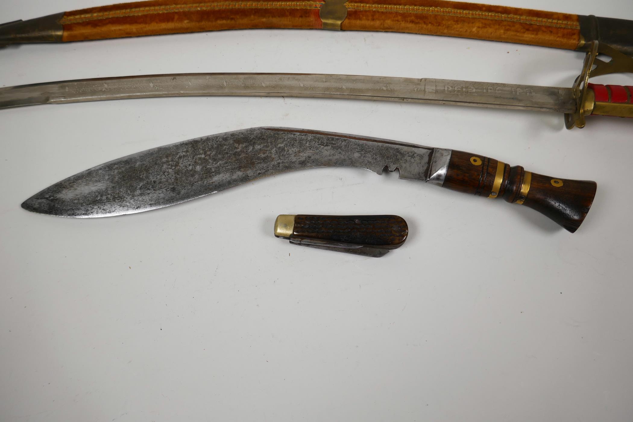 An Oriental Indian sword in velvet covered scabbard, 27½" long together with a wood and brass - Image 4 of 5