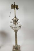 A silver plate and glass table lamp in the form of an oil lamp with classical column base and