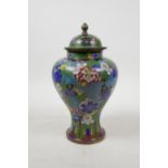 A Chinese cloisonne baluster jar and cover with all over floral decoration, 9" high