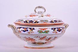 An 1873 Minton stately porcelain oval tureen in the Imari style, and matching domed cover, with