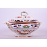 An 1873 Minton stately porcelain oval tureen in the Imari style, and matching domed cover, with