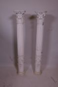 A pair of ribbed wood columns with floral swag bases and acanthus leaf crests, 38½" high