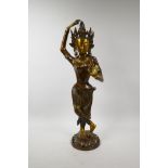 A large wooden bronze of Shiva with inset beads to her crown and bangles, 25" high