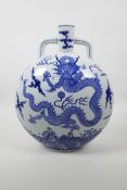 A Chinese blue and white porcelain two handled moon flask decorated with a dragon and flaming pearl,