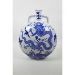 A Chinese blue and white porcelain two handled moon flask decorated with a dragon and flaming pearl,