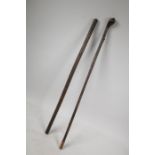 A leather bound riding crop and another similar, longest 26"