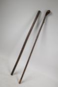 A leather bound riding crop and another similar, longest 26"