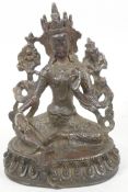 A Tibetan bronze figure of Guan Yin seated in meditation, 7" high