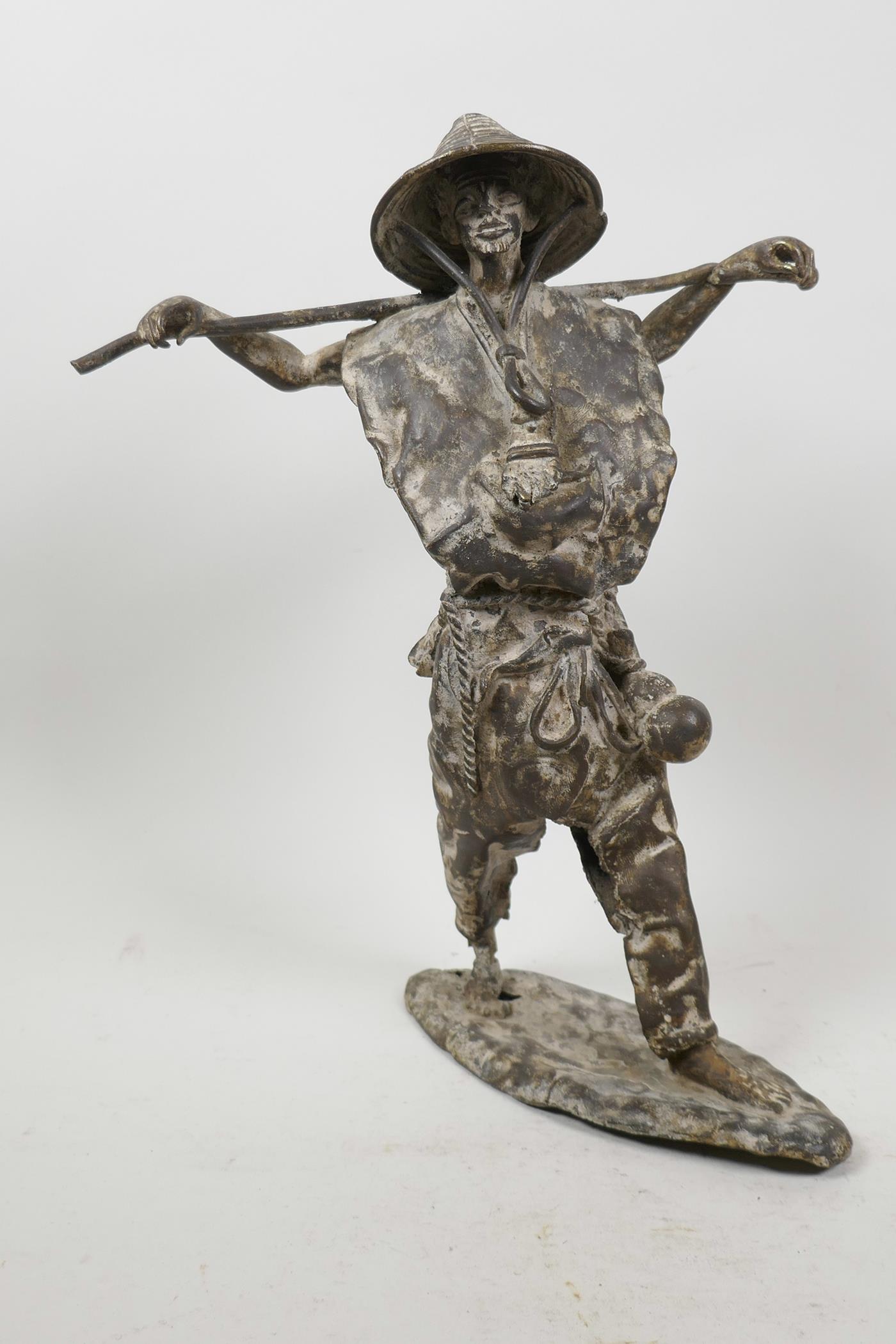 A Chinese stylised bronze figure of a fisherman, 13" high
